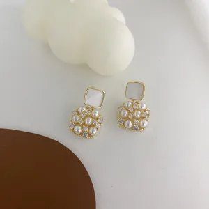 Exquisite vintage square pearl earrings detail view, elegant mother-of-pearl design.