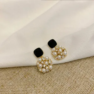 Elegant vintage square pearl earrings featuring sparkling rhinestones and chic black enamel design.