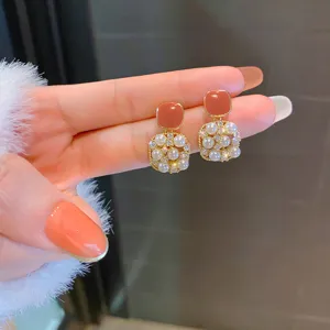 Elegant square pearl earrings with chic peach enamel and sparkling rhinestones for women.