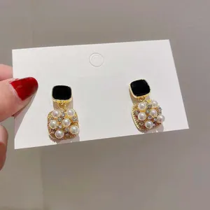 Elegant French vintage square pearl earrings with black gemstone accents for women.