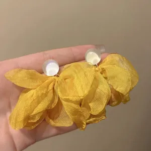 Yellow fabric flower earrings with white round stud, elegant and lightweight design for women.