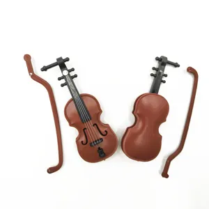 Detailed shot of miniature violin toy model with bow, perfect for dollhouse decor and crafts.