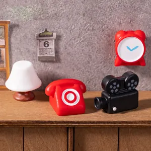 Detailed closeup view of mini dollhouse retro telephone camera and lamp ornaments for diy crafts.
