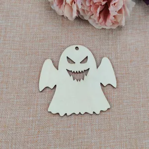 Wooden ghost ornament detail, showing scary face cutout and hanging hole for DIY Halloween.