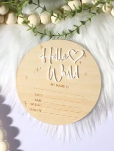 Wooden newborn birth announcement milestone board detail, laser cut Hello World plaque.