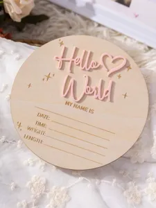 Wooden newborn milestone card detail view featuring Hello World text and baby data spaces