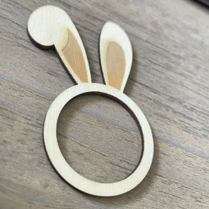 Wooden bunny ear napkin ring detail, cute Easter table decor and rustic dining table accessory.