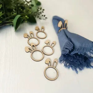 Wooden bunny ear napkin rings detail shot, rustic table decor for holiday party dining.