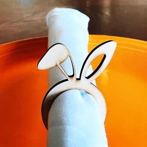Close-up detail view of the creative wooden bunny ear napkin ring used for table decor.