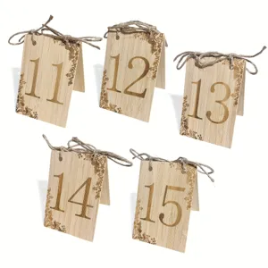 Wooden table number cards 11-15 with jute twine bow for wedding party decor detail.