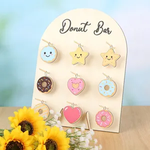 Wooden arch donut bar display stand with cute cartoon hanging pendants detail view showcase.