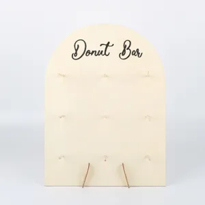 Wooden arch donut display stand with natural texture, ideal for wedding dessert party tables setup.