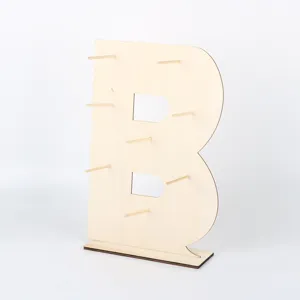 Wooden letter B donut display stand detail, perfect for wedding party dessert table decoration.