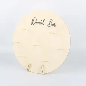 Close-up detail of the wooden donut display stand, showing the pegs and natural wood grain texture.