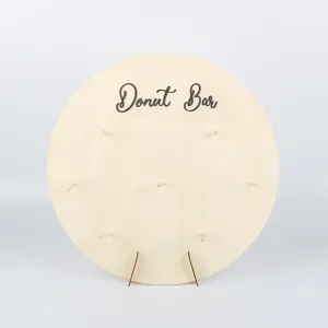 Wooden donut wall display stand detail view, showing natural wood texture and pegs.