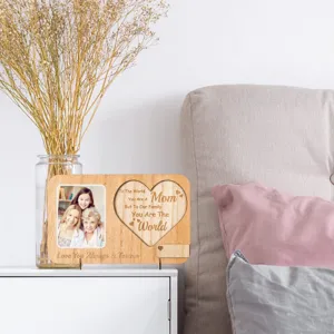 Wooden photo frame detail, engraved heart text, warm bedroom desktop decor, family memory.