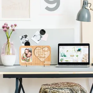 Wooden photo frame detail showing engraved heart text and desk setup lifestyle view.