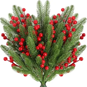 Artificial pine branches with red berries for Christmas tree and home decor floral arrangement.