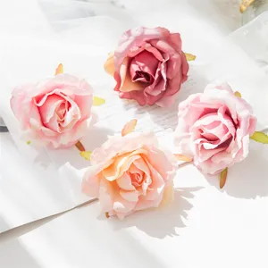 Artificial rose flower heads for DIY crafts, wedding decoration and home decor details.