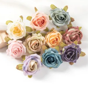 Detailed view of colorful artificial silk rose heads, perfect for DIY crafts and wedding decorations.