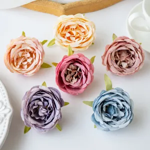 Detailed view of colorful artificial silk peony rose flower heads for DIY crafts and wedding decor.