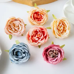 Artificial silk peony and rose flower heads for DIY crafts, wedding and home decor detail shot.