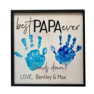Detailed view of DIY wooden handprint father's day gift sign with blue hand prints and text.