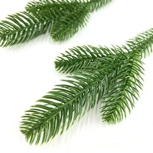 Detail shot of artificial pine needles, 3-prong fake pine branch for Christmas decoration.