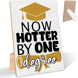 Wooden graduation plaque detail view, featuring graduation cap design and stand on back.
