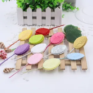 Artificial colored wire leaves for DIY wedding garland crafts, floral accessories, detailed view.