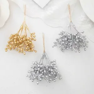 Gold and silver artificial berry bundles for Christmas wreath DIY craft detail display.
