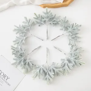Artificial Christmas pine branches snowy frosted picks for festive wreath decor.