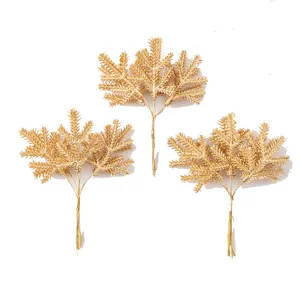 Gold artificial pine branches for Christmas tree decoration, wreath and holiday party floral supplies.
