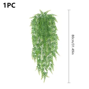 Artificial hanging fern vine detail view, realistic green plant decoration for indoor home.