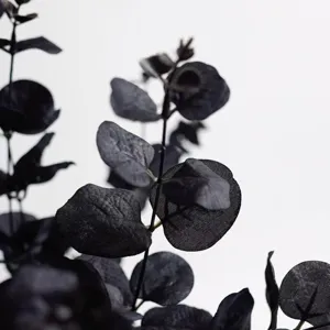 Black artificial eucalyptus leaf branch detail, gothic style plant decor for party and home use.