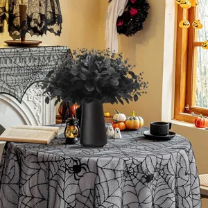 Detailed view of black artificial eucalyptus plant in a sleek vase for Halloween party decor.
