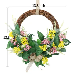 Detail view of artificial floral wreath with yellow and pink flowers and burlap bow hanger.