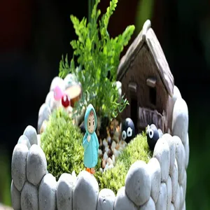 Miniature resin landscape ornament with house and cute cartoon figurine for DIY terrarium decor.