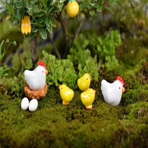 Close-up of cute miniature resin chicken figurines and moss micro landscape decoration props.