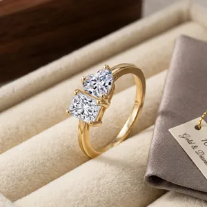 Macro view of 18K gold ring featuring heart and princess cut lab-grown diamonds