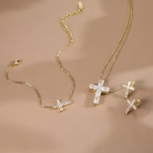 Detailansicht eines vergoldeten 925er Silber-Kreuzschmucksets mit Baguette-Steinen