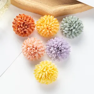 Detailed close-up of colorful artificial silk flower heads for DIY crafts and wedding decor.