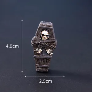 Close-up detail of Halloween miniature resin skull coffin figurine, gothic spooky decor ornament.