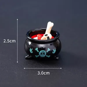 Miniature Halloween skull cauldron ornament detail view, spooky resin desktop decoration item.