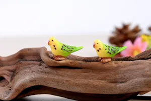 Closeup detail shot of cute resin parakeet miniature figurines, ideal for creative DIY landscaping.