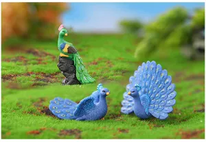 Miniature resin peacock figurines detail shot for micro landscape and cake decoration.