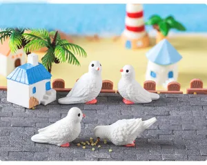 Miniature white dove figurines micro landscape detail shot for creative beach island decor