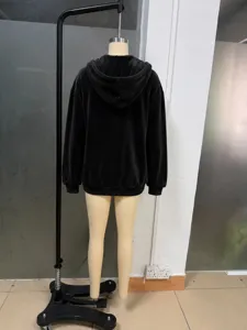 Back detail view of black velvet hooded zip-up sweatshirt, soft fabric and comfortable fit.