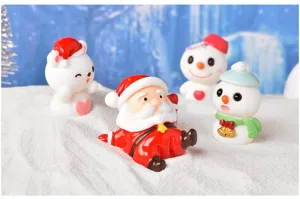 Detailed view of cute Christmas resin Santa Claus and snowman figurines for winter wonderland decor.