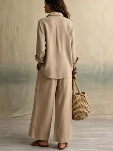 Detail view of the elegant linen-cotton shirt and wide-leg pants set in a stylish room.